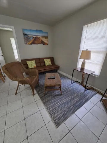 a living room with furniture and a rug