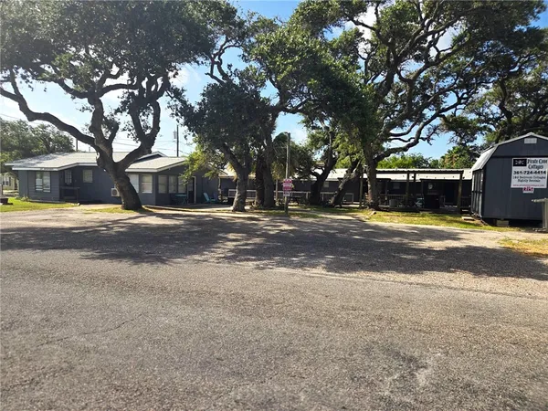 a view of a building with trees in the background