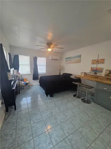 a living room with furniture a flat screen tv and dresser