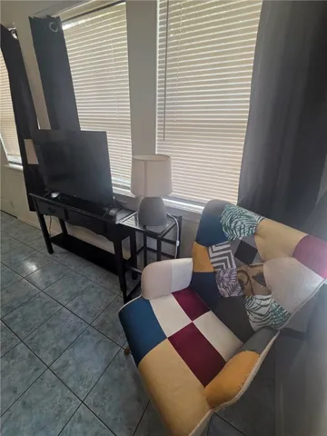 a living room with furniture and next to a window