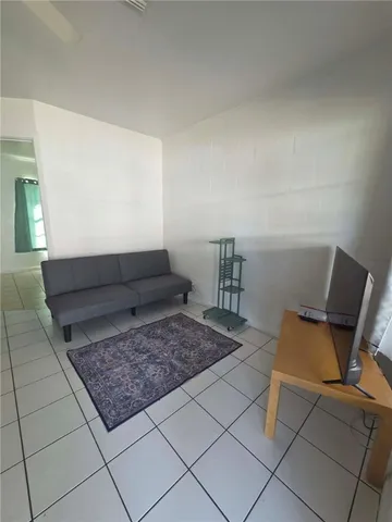a living room with a couch and a stove top oven