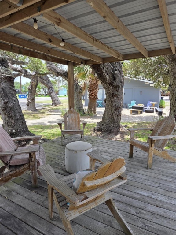 302 Broadway Street Fulton, TX 78382 - Photo 8 of 38 a view of a patio with table and chairs potted plants with wooden floor