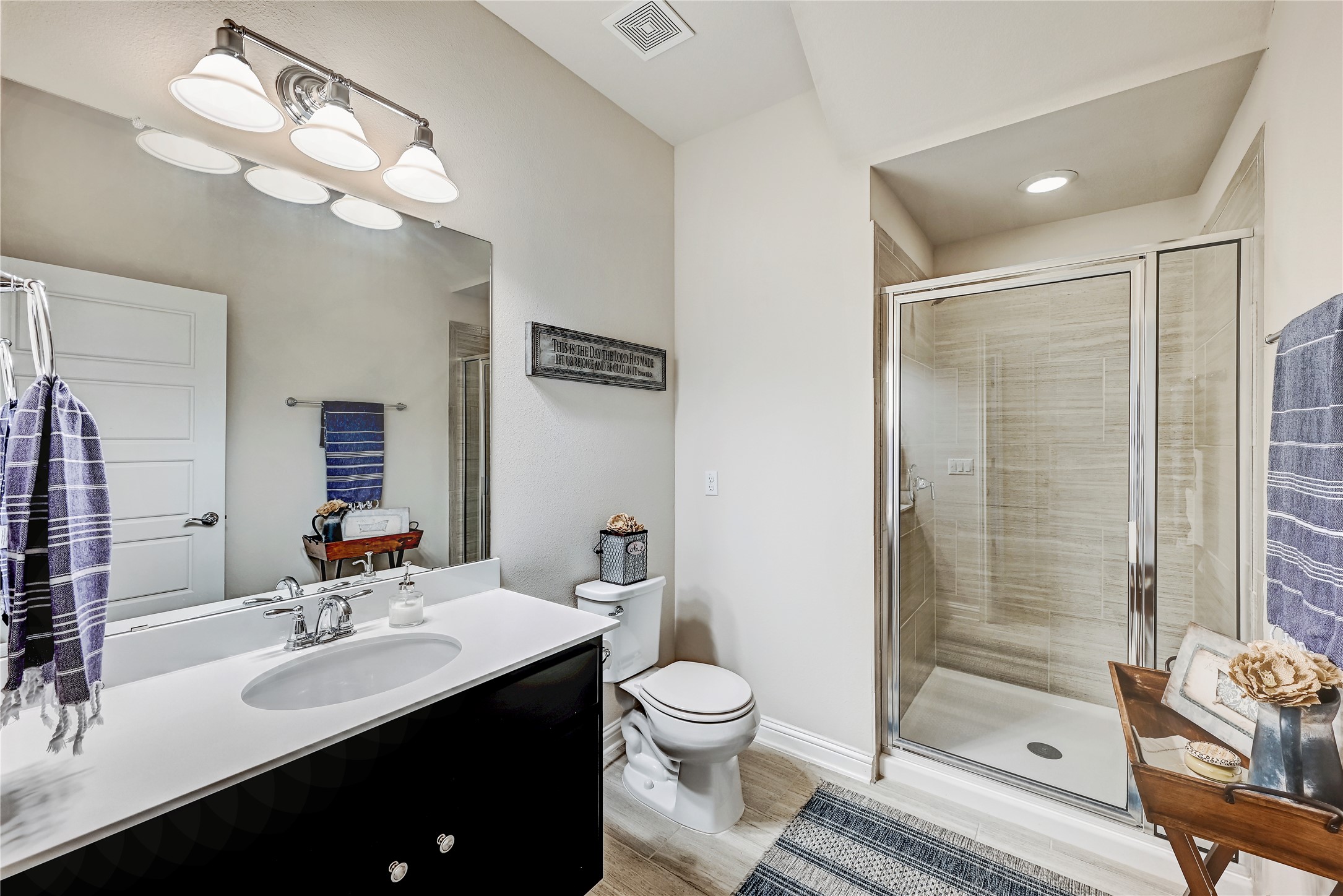 6814 East Riverside Drive, Unit 64 Austin, TX 78741 - Photo 13 of 17 A well-lit primary bathroom featuring a spacious walk-in shower and a sleek vanity.