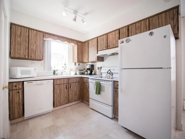 a white refrigerator freezer sitting in a kitchen