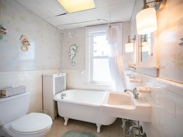 a bathroom with a sink a toilet and a bathtub