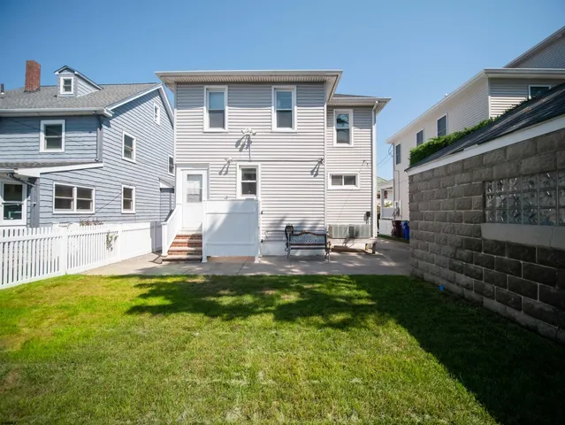 a view of a house with a yard porch and sitting area
