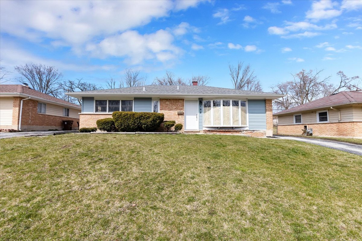 192 Monee Road Park Forest, IL 60466 - Photo 1 of 25 a front view of a house with a yard