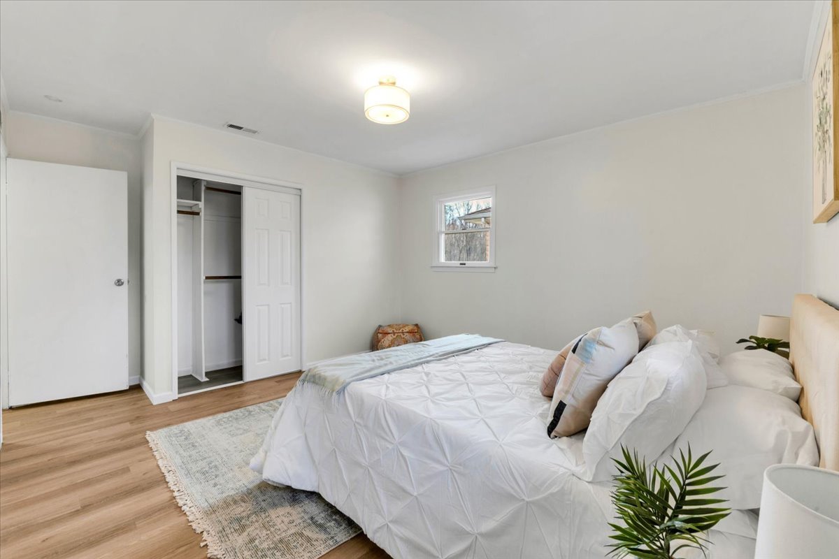 192 Monee Road Park Forest, IL 60466 - Photo 11 of 25 a bedroom with a bed and a potted plant