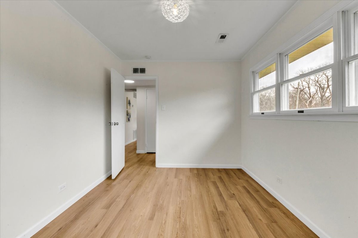 192 Monee Road Park Forest, IL 60466 - Photo 14 of 25 a view of a room with wooden floor and a window