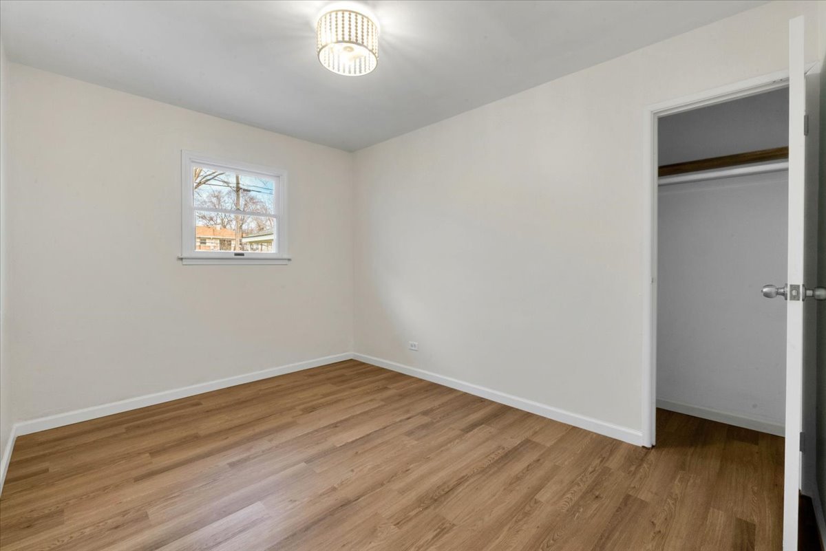 192 Monee Road Park Forest, IL 60466 - Photo 16 of 25 wooden floor in an empty room with a window