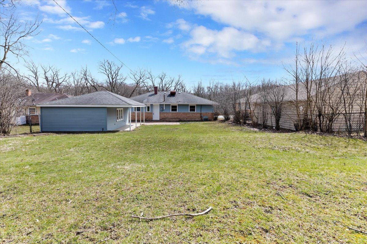192 Monee Road Park Forest, IL 60466 - Photo 22 of 25 a view of a house with a big yard and a large tree