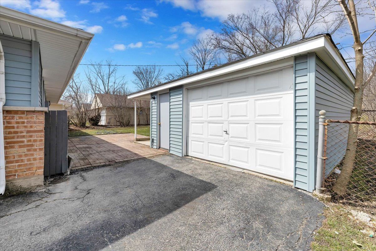 192 Monee Road Park Forest, IL 60466 - Photo 24 of 25 a view of a house with a yard and garage