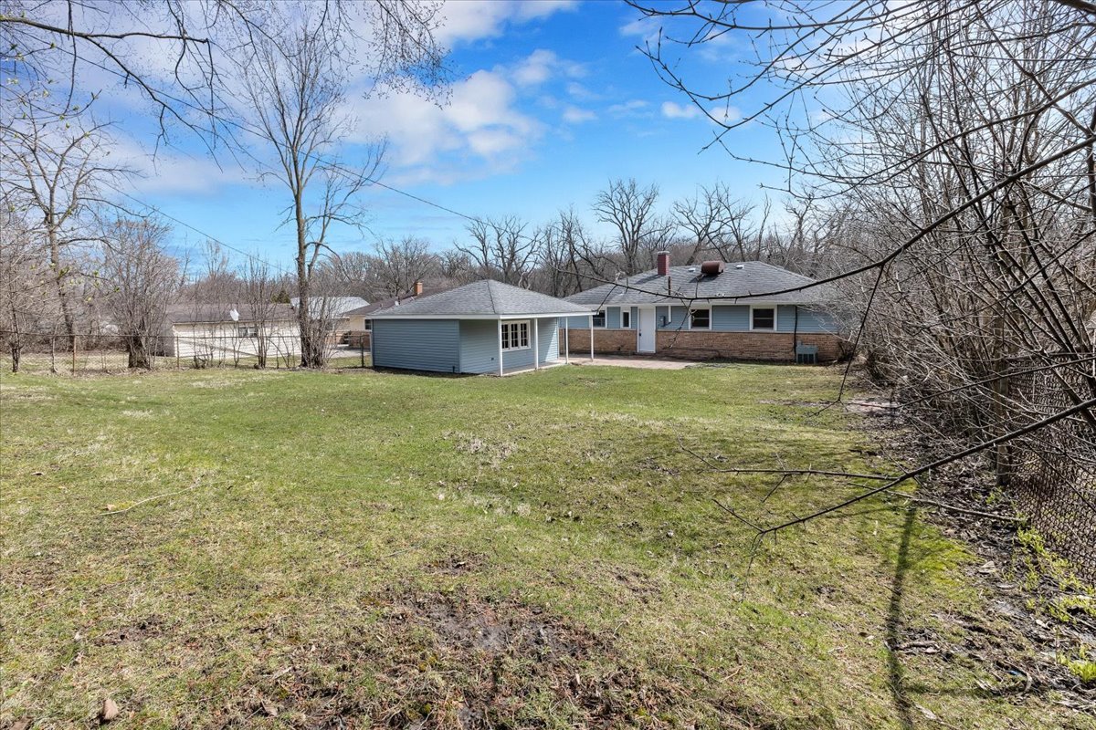 192 Monee Road Park Forest, IL 60466 - Photo 25 of 25 a view of a house with a big yard and large trees