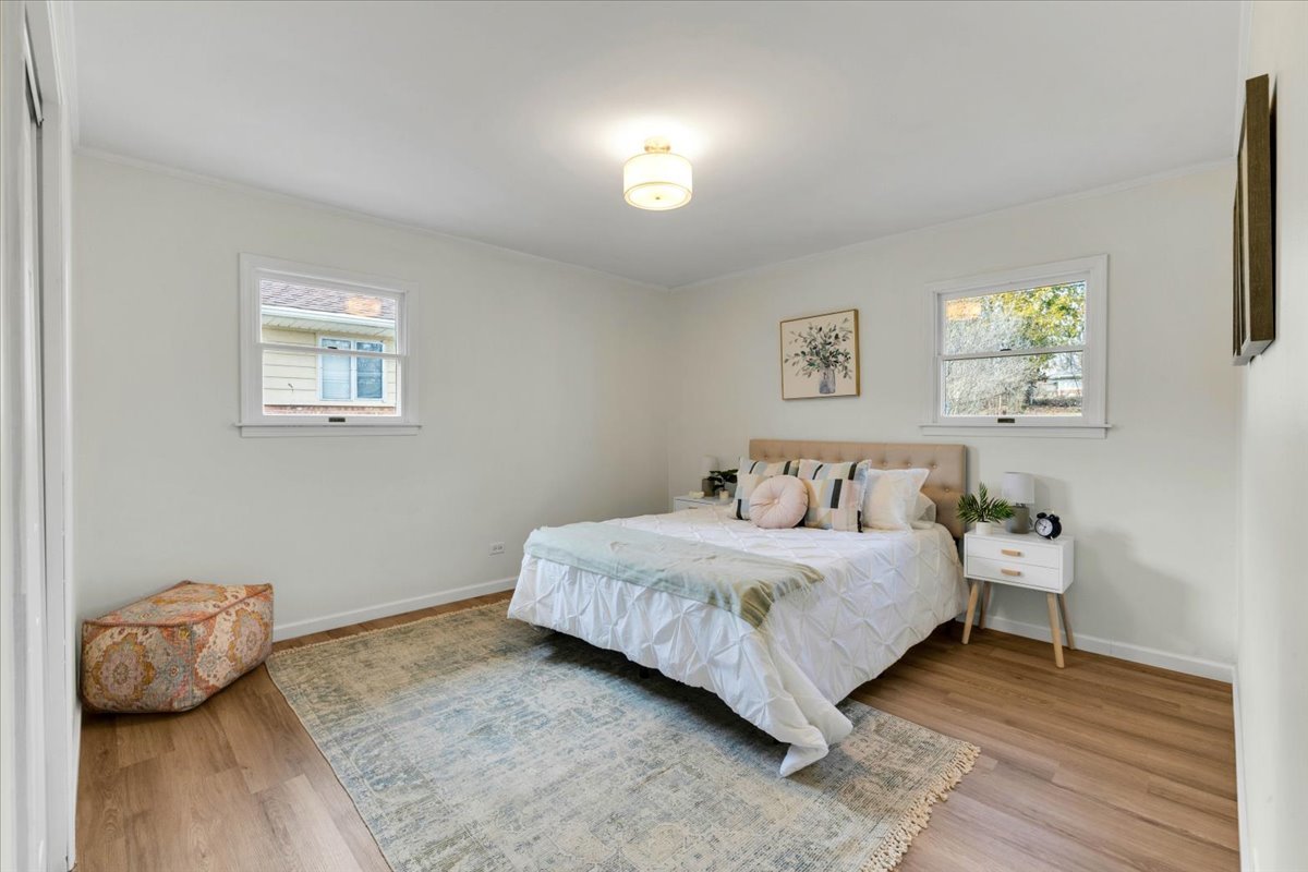 192 Monee Road Park Forest, IL 60466 - Photo 10 of 25 a bedroom with a bed and wooden floor
