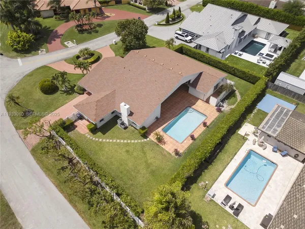 an aerial view of residential houses with outdoor space