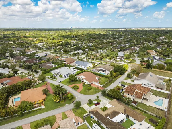 an aerial view of residential houses with outdoor space