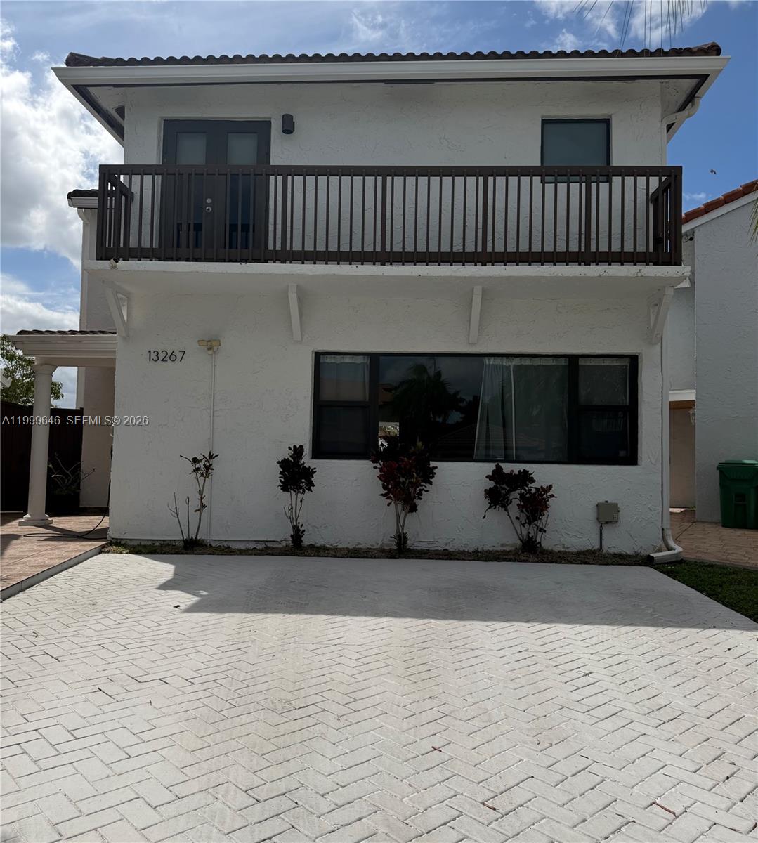 13267 Southwest 9th Lane Miami, FL 33184 - Photo 1 of 53 a front view of a house with a yard