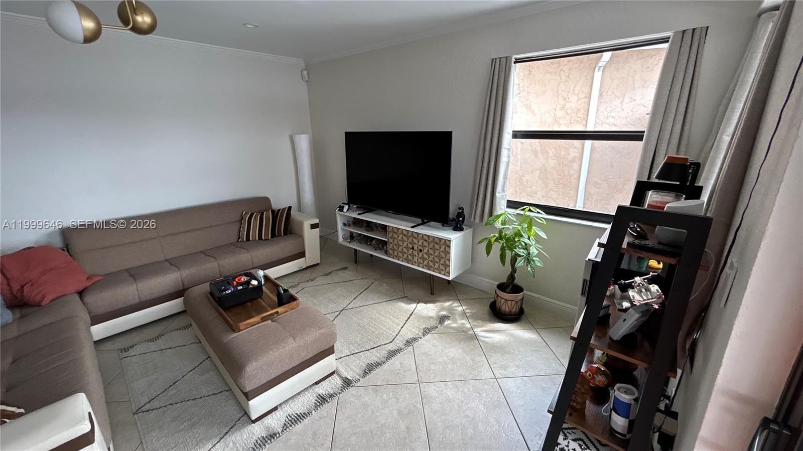 13267 Southwest 9th Lane Miami, FL 33184 - Photo 14 of 53 a living room with furniture a window and a flat screen tv