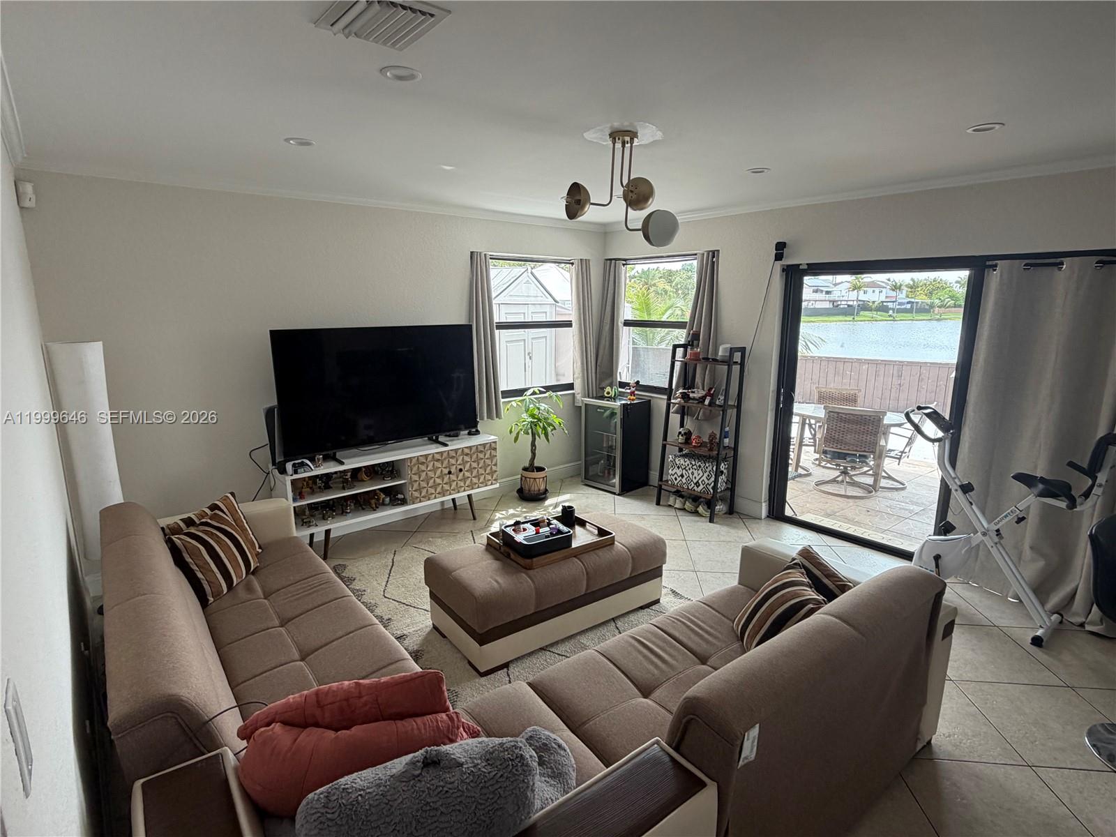 13267 Southwest 9th Lane Miami, FL 33184 - Photo 15 of 53 a living room with furniture and a flat screen tv