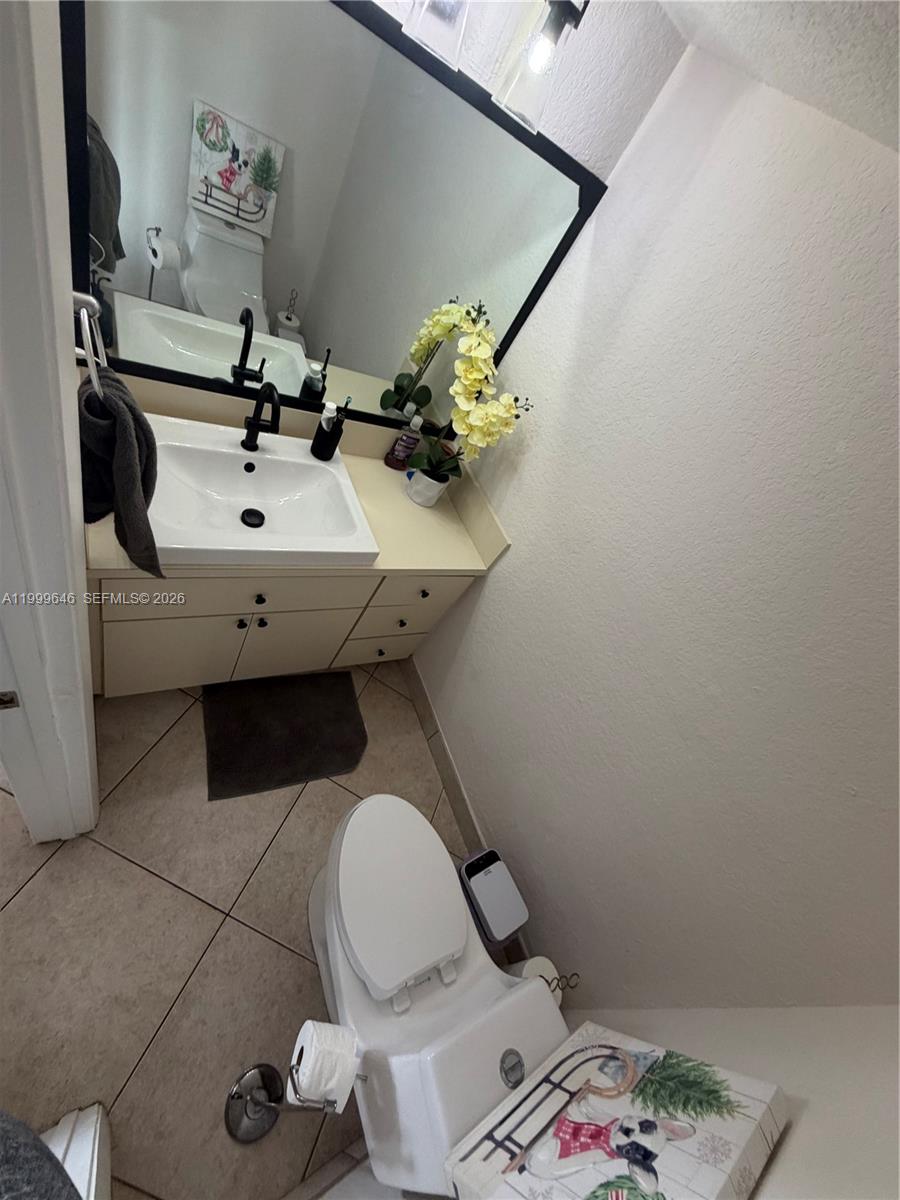 13267 Southwest 9th Lane Miami, FL 33184 - Photo 19 of 53 a bathroom with a sink mirror and toilet
