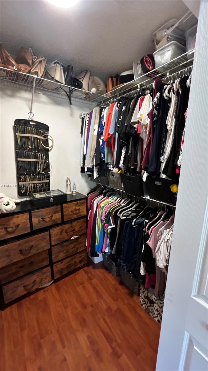 13267 Southwest 9th Lane Miami, FL 33184 - Photo 28 of 53 a view of walk in closet with clothes and shoes