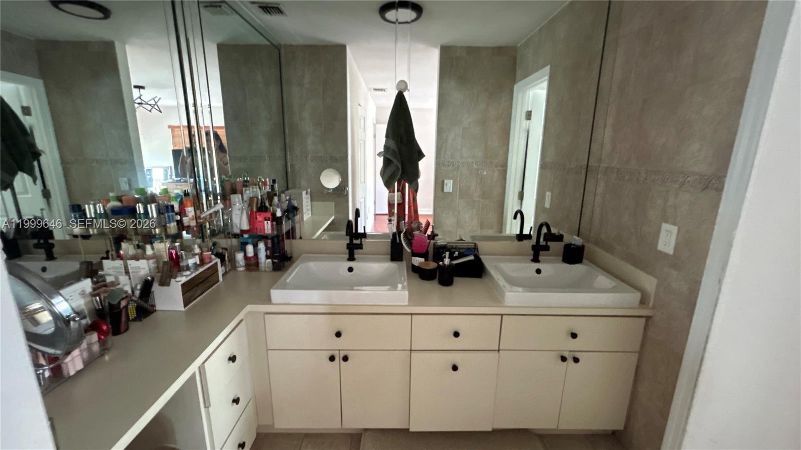 13267 Southwest 9th Lane Miami, FL 33184 - Photo 30 of 53 a bathroom with cabinets and mirror
