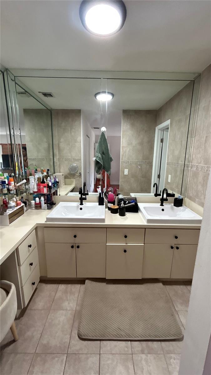 13267 Southwest 9th Lane Miami, FL 33184 - Photo 31 of 53 a bathroom with a sink vanity and mirror