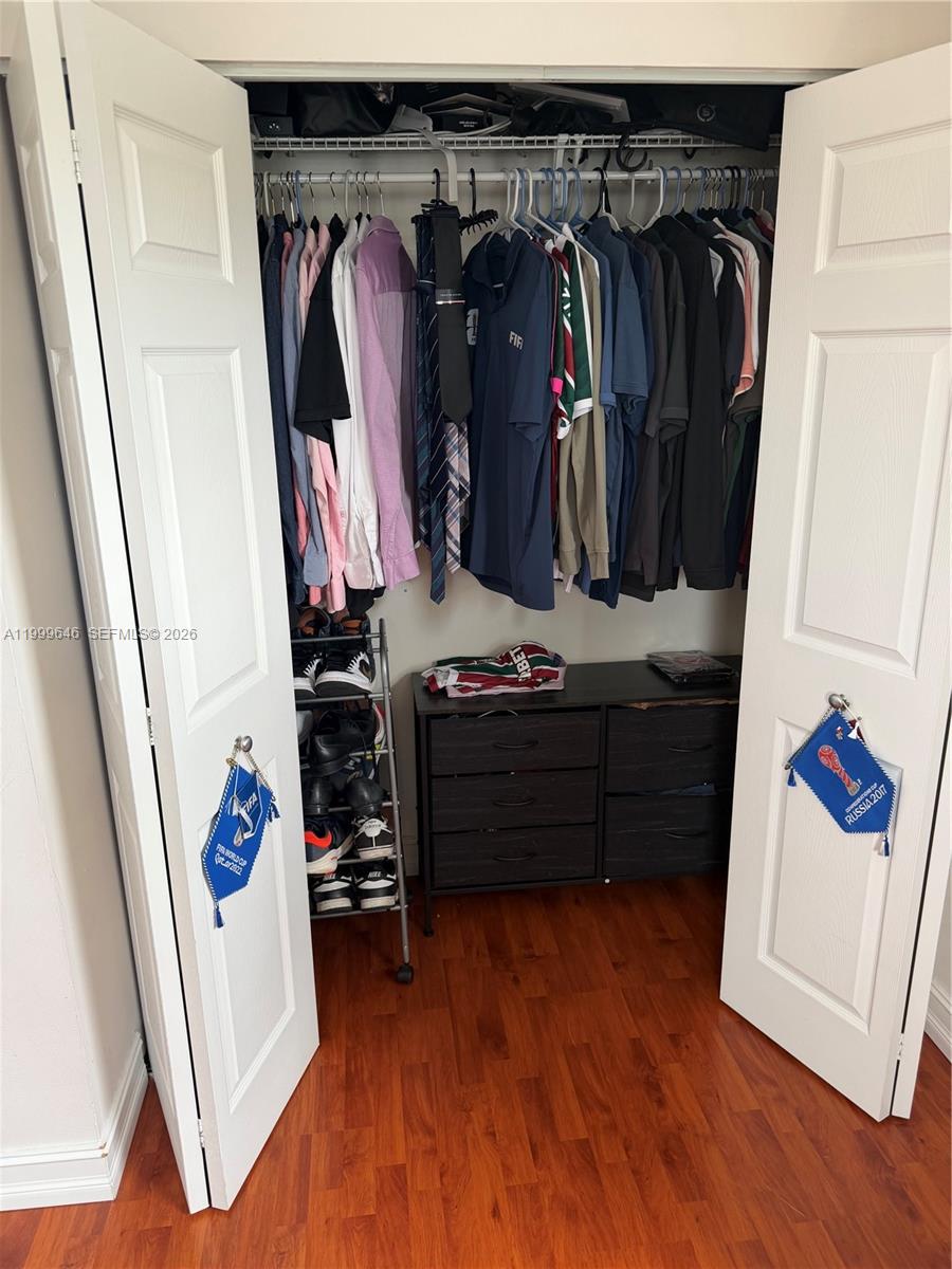 13267 Southwest 9th Lane Miami, FL 33184 - Photo 39 of 53 a view of walk in closet with clothes and shoes