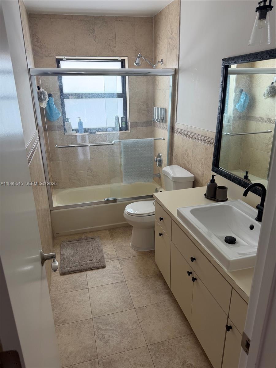 13267 Southwest 9th Lane Miami, FL 33184 - Photo 40 of 53 a bathroom with a double vanity sink toilet and a mirror