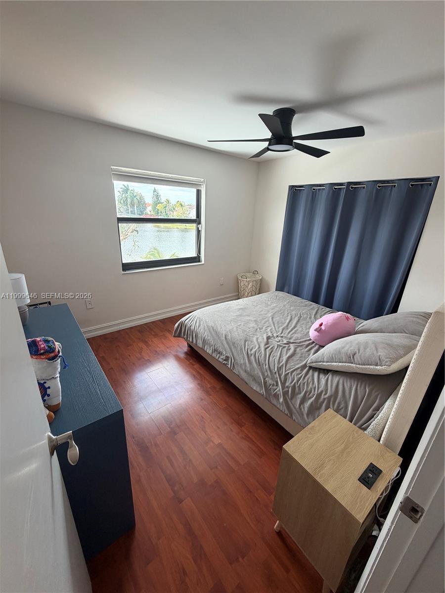 13267 Southwest 9th Lane Miami, FL 33184 - Photo 41 of 53 a bedroom with a bed and wooden floor