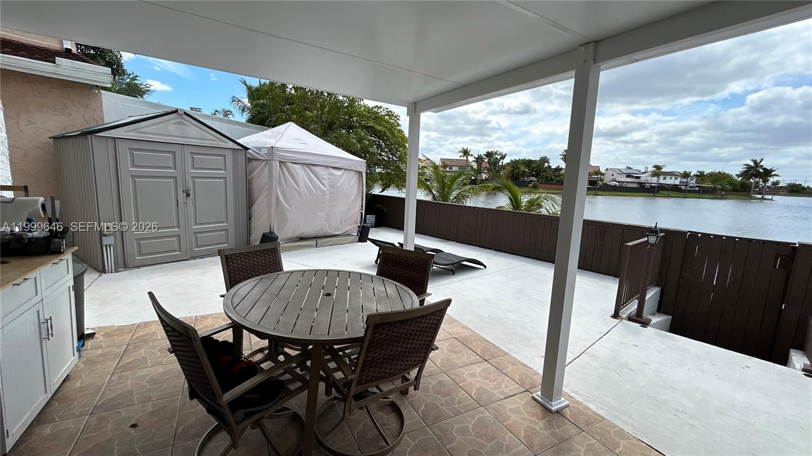 13267 Southwest 9th Lane Miami, FL 33184 - Photo 43 of 53 a view of a patio with a table chairs and a backyard