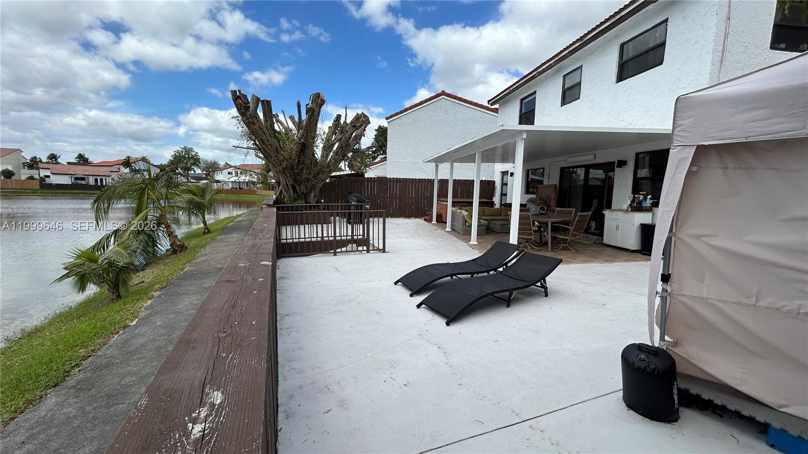 13267 Southwest 9th Lane Miami, FL 33184 - Photo 50 of 53 a view of a patio with table and chairs under an umbrella