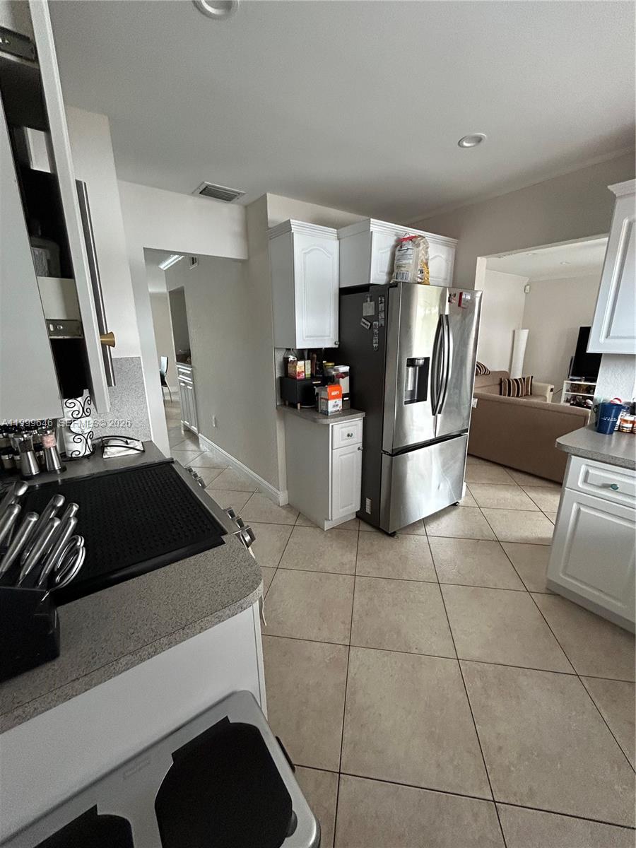 13267 Southwest 9th Lane Miami, FL 33184 - Photo 10 of 53 a kitchen with a stove and a refrigerator