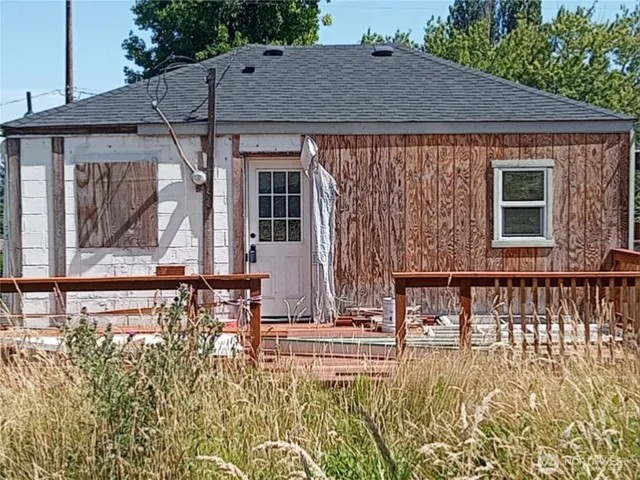 a backyard of a house with table and chairs