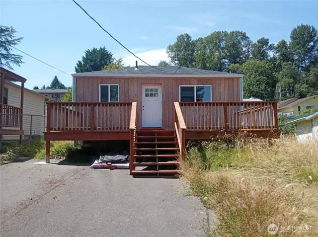 a view of a house with wooden fence