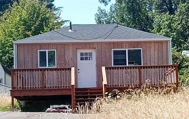 a view of a house with a wooden fence