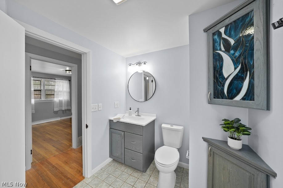 3235 Chapel Road Ashtabula, OH 44004 - Photo 6 of 13 Bathroom with vanity, toilet, and hardwood / wood-style floors