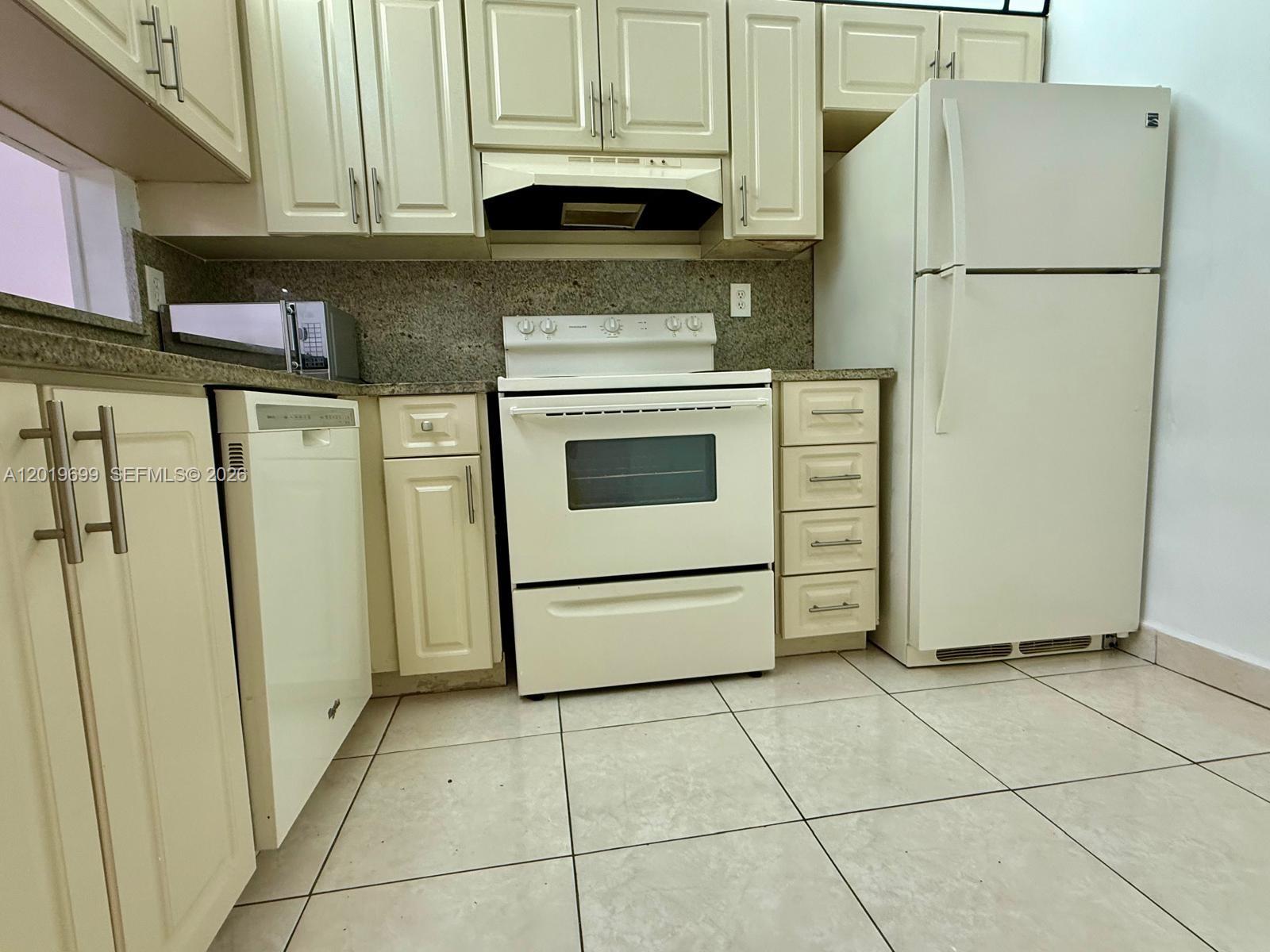 3470 Foxcroft Road, Unit 204 Miramar, FL 33025 - Photo 13 of 40 a kitchen with stainless steel appliances granite countertop a refrigerator and a stove