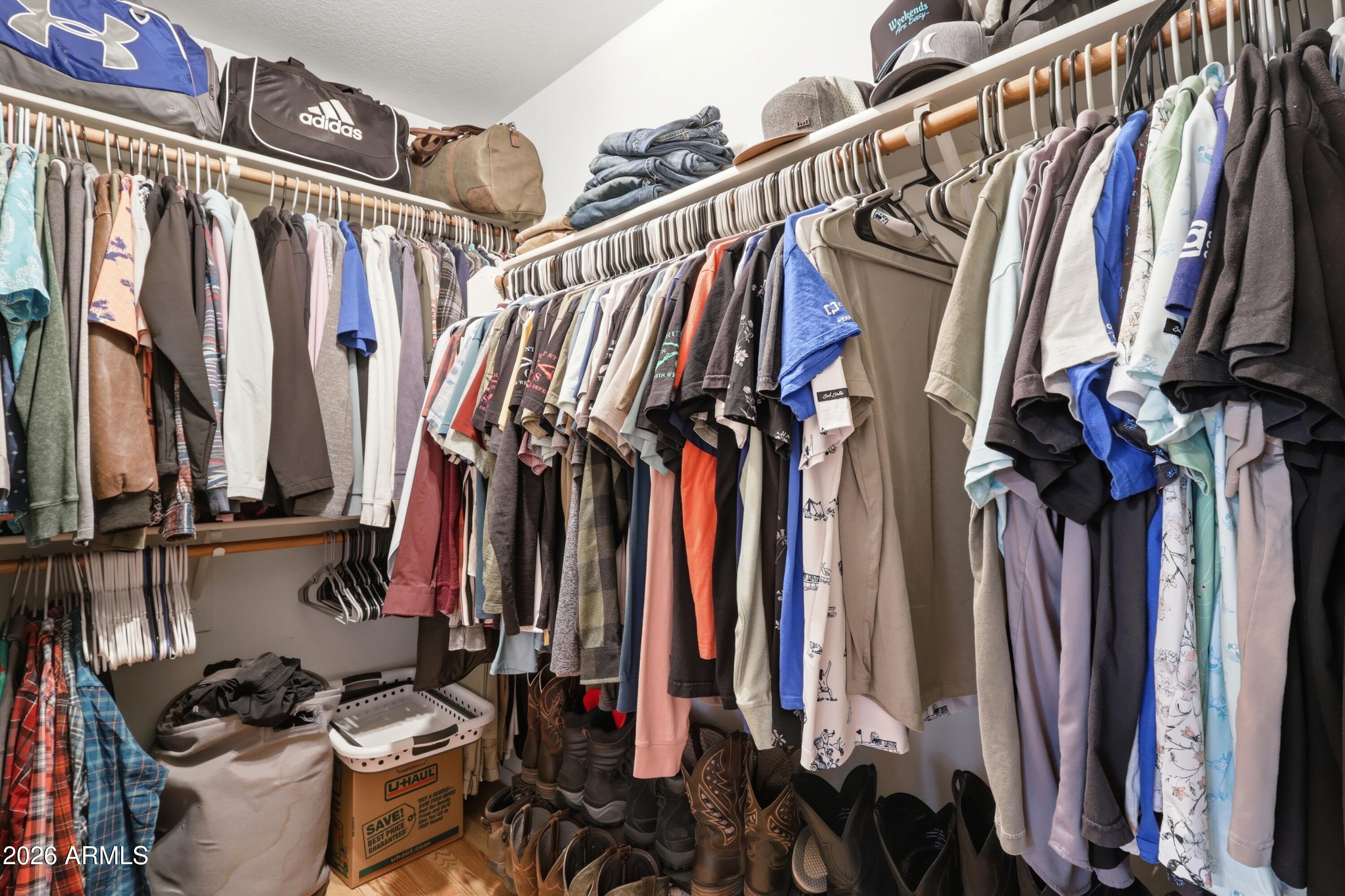 661 North Joshua Tree Lane Gilbert, AZ 85234 - Photo 22 of 47 a view of walk in closet with clothes and shoes