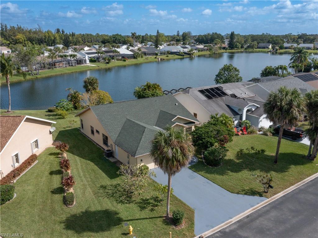 an aerial view of a house with outdoor space and lake view