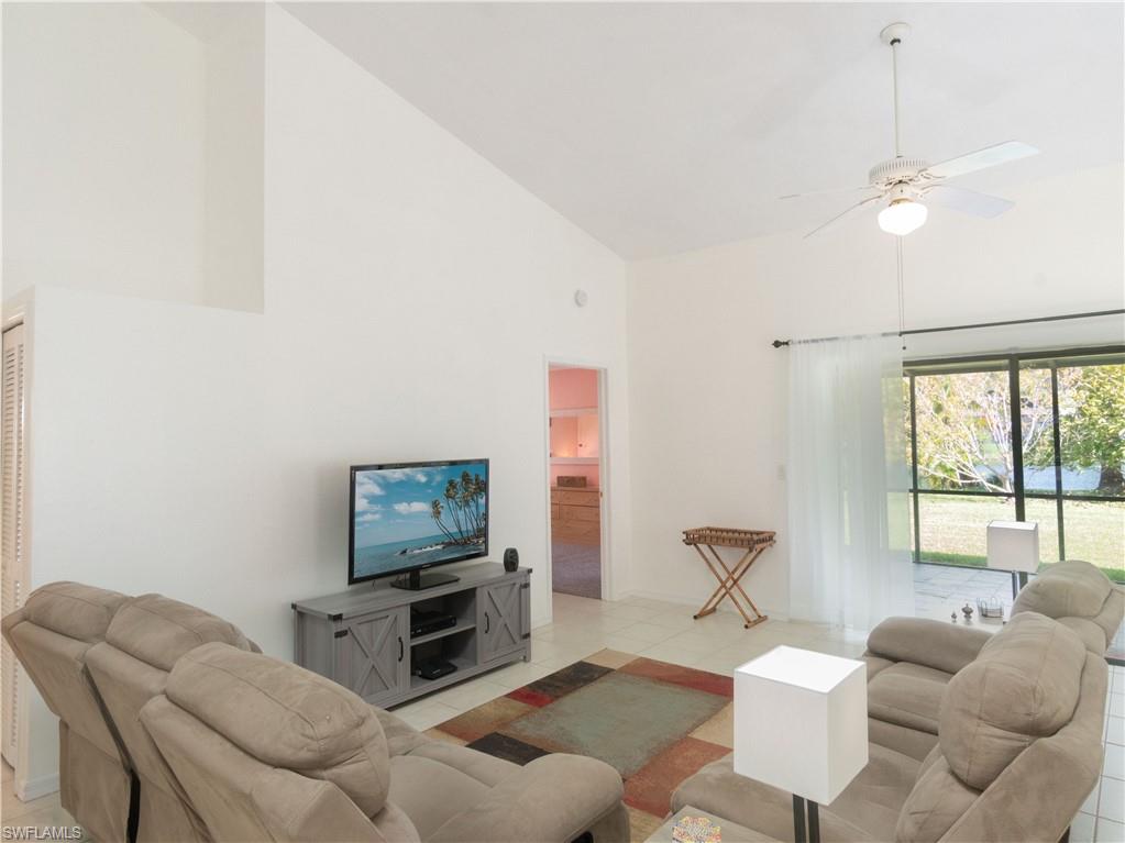 1404 Monarch Circle Naples, FL 34116 - Photo 11 of 33 a living room with furniture and a flat screen tv