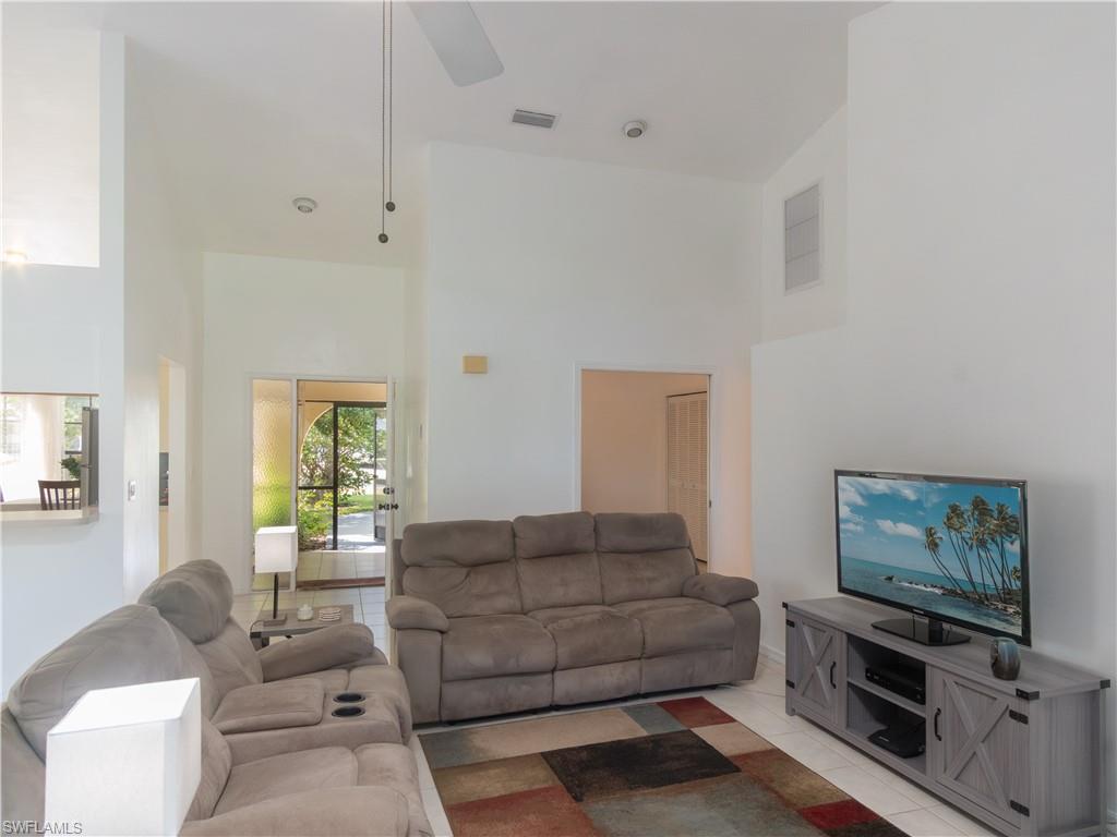 1404 Monarch Circle Naples, FL 34116 - Photo 12 of 33 a living room with furniture and a flat screen tv