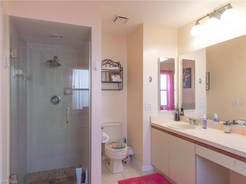 1404 Monarch Circle Naples, FL 34116 - Photo 21 of 33 a bathroom with a sink a toilet and shower