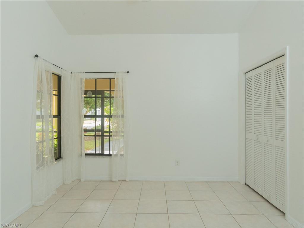 1404 Monarch Circle Naples, FL 34116 - Photo 23 of 33 an empty room with windows