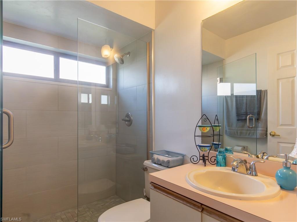 1404 Monarch Circle Naples, FL 34116 - Photo 25 of 33 a bathroom with a sink toilet and shower