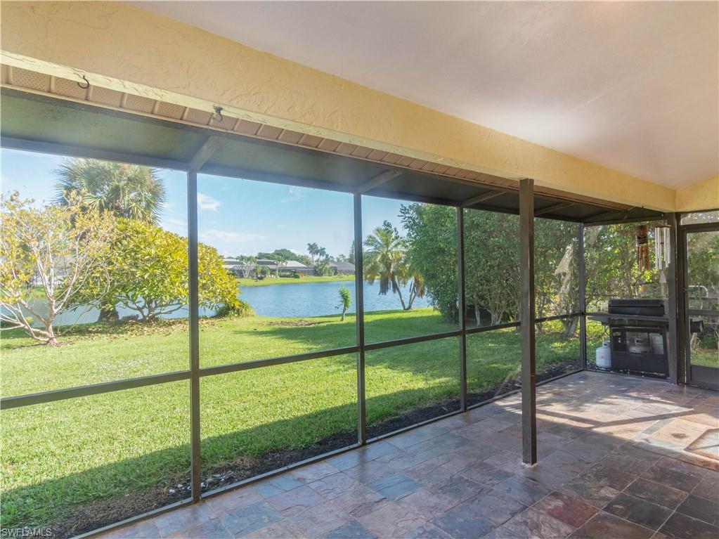 1404 Monarch Circle Naples, FL 34116 - Photo 30 of 33 a view of a porch with a floor to ceiling window next to a yard