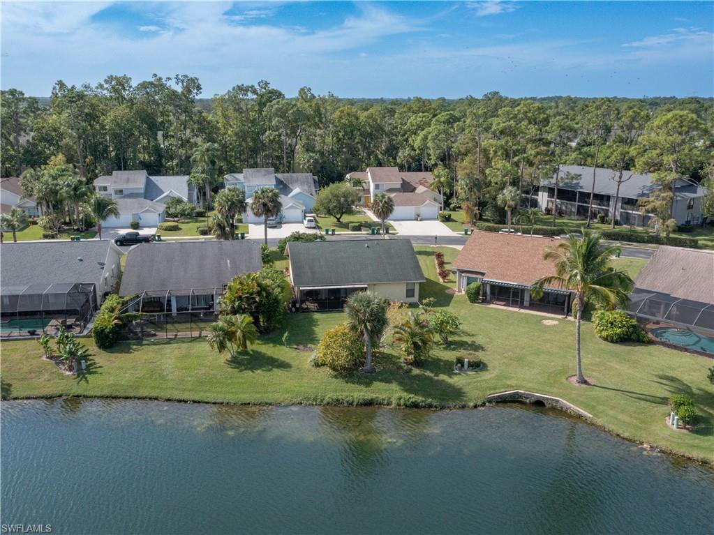 1404 Monarch Circle Naples, FL 34116 - Photo 4 of 33 an aerial view of a house with a garden and lake view