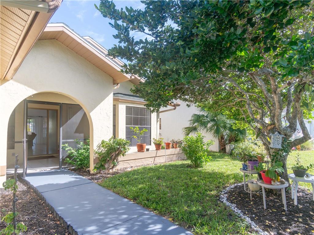 1404 Monarch Circle Naples, FL 34116 - Photo 7 of 33 a view of a chair and table in backyard of the house