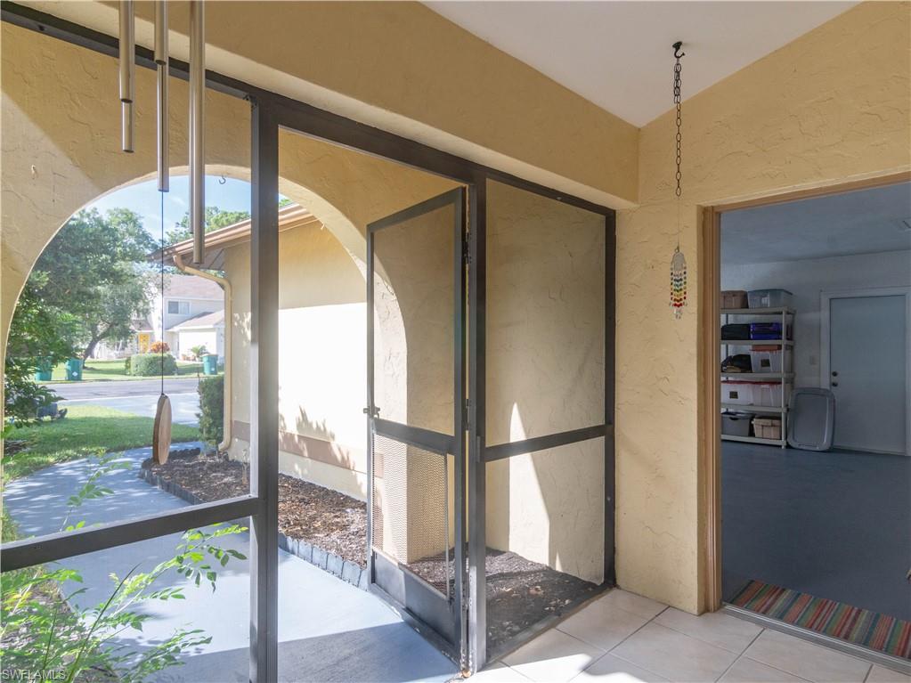 1404 Monarch Circle Naples, FL 34116 - Photo 8 of 33 a bathroom with a glass shower door and a yard