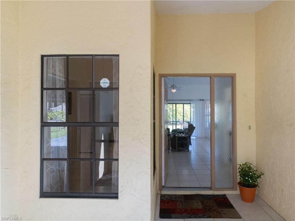 1404 Monarch Circle Naples, FL 34116 - Photo 9 of 33 a view of a hallway with wooden floor and dining room view